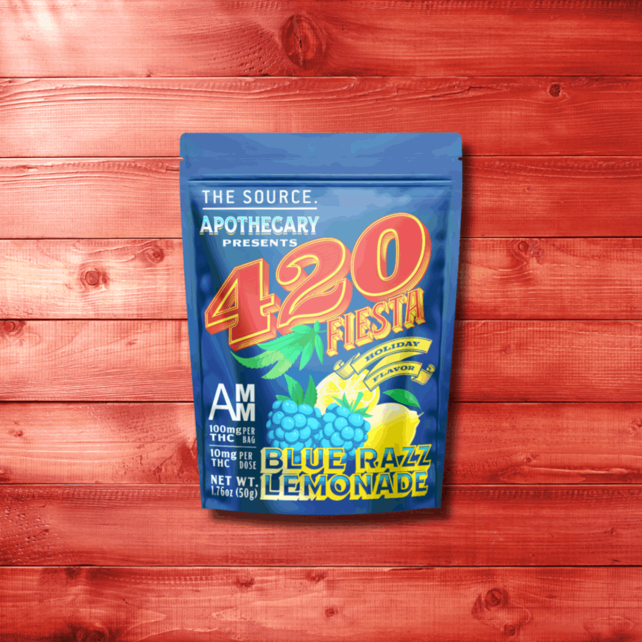 Image depicts The Source Apothecary’s new 420 Fiesta Limited-Edition flavor, Blue Razz Lemonade. The image shows blue kraft paper packaging on top of a tinted red wood background. Inside of the packaging are high quality cannabis infused edibles from The Source Craft Cannabis Company in Rogers, Arkansas.