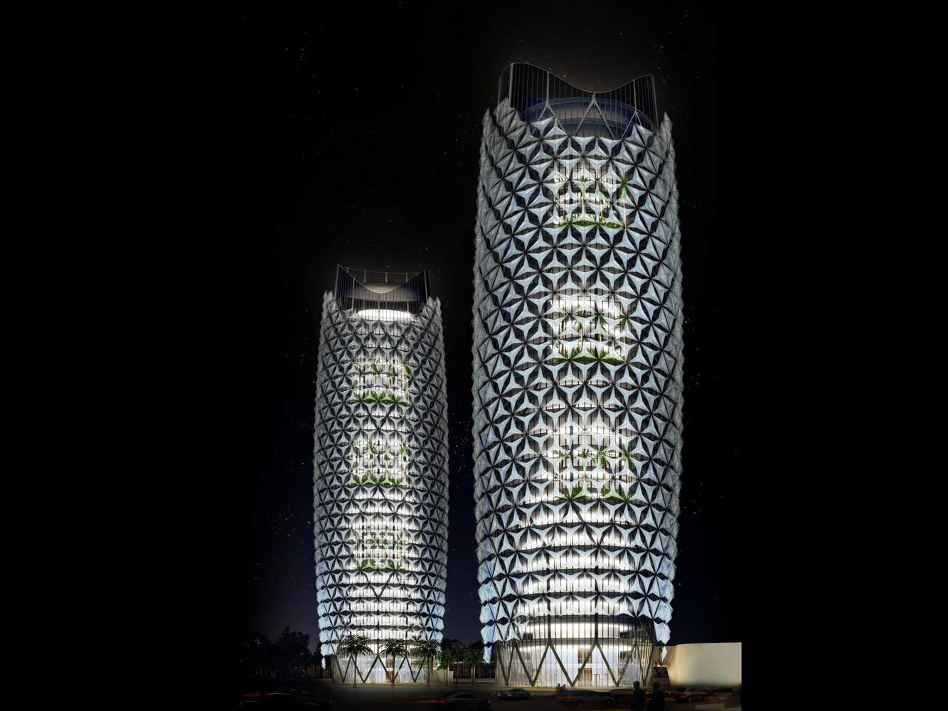 Two illuminated, modern skyscrapers with a unique lattice design stand against a night sky. These landmark buildings feature green balconies, showcasing a blend of sustainability and architecture.