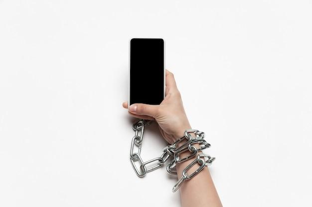 Close up of human hand using gadget with blank black screen