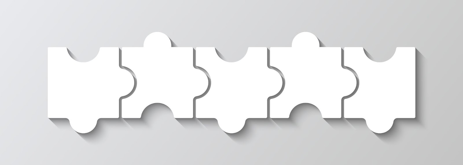 Five white interlocking puzzle pieces laid out in a horizontal row. 
