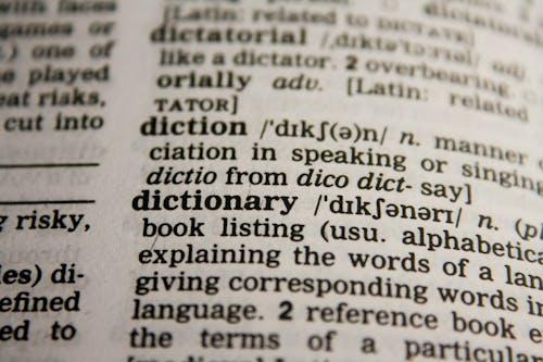 Free Detailed close-up view of a dictionary page highlighting the word 'dictionary' and its definition. Stock Photo