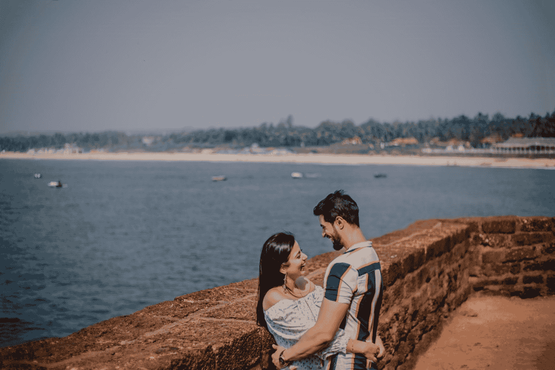 pre-wedding photoshoot of a couple in Fort Aguada holding each other and smiling joyfully. 