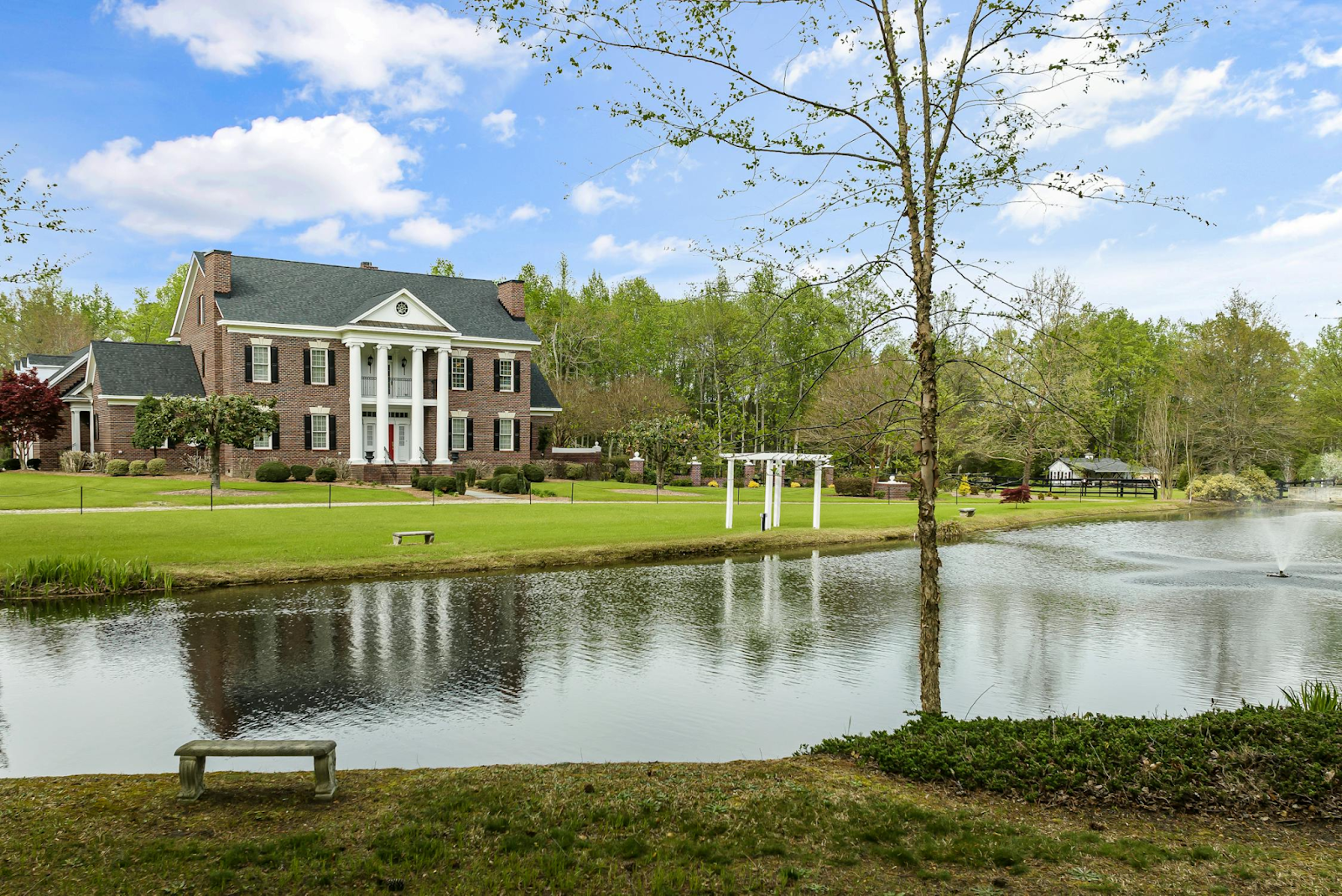 Large house with a pond and fountain