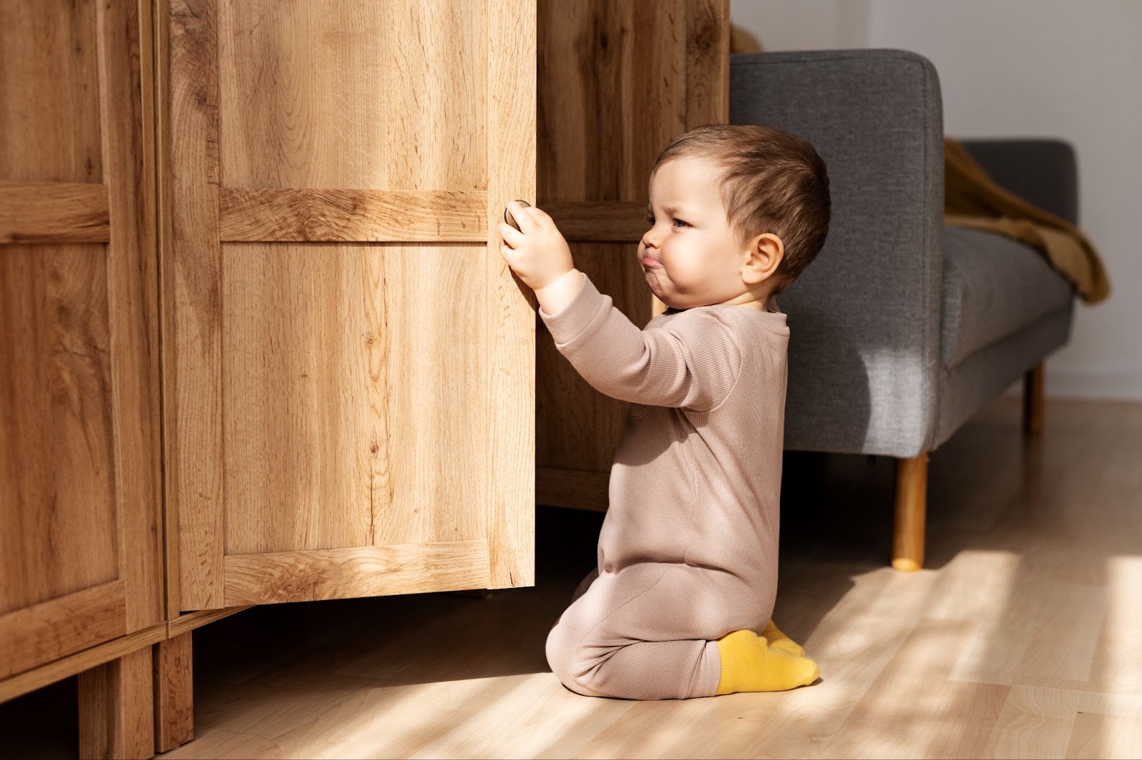 A little boy opening the cabinet