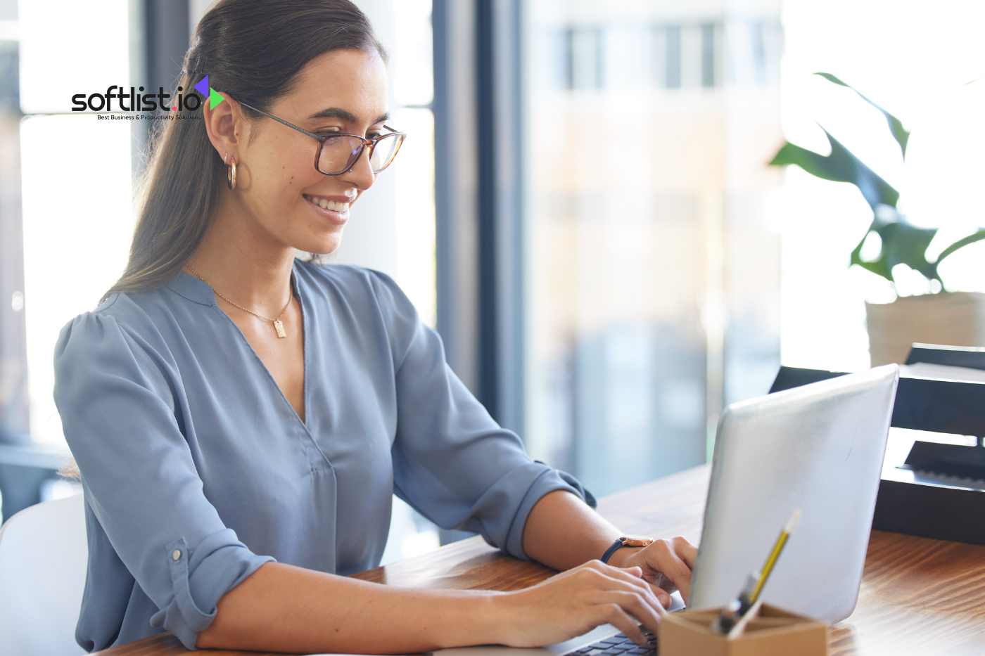 a woman typing to her laptop