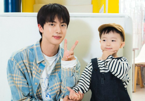 This contains an image of BTS Jin and  three-year-old Taeha.