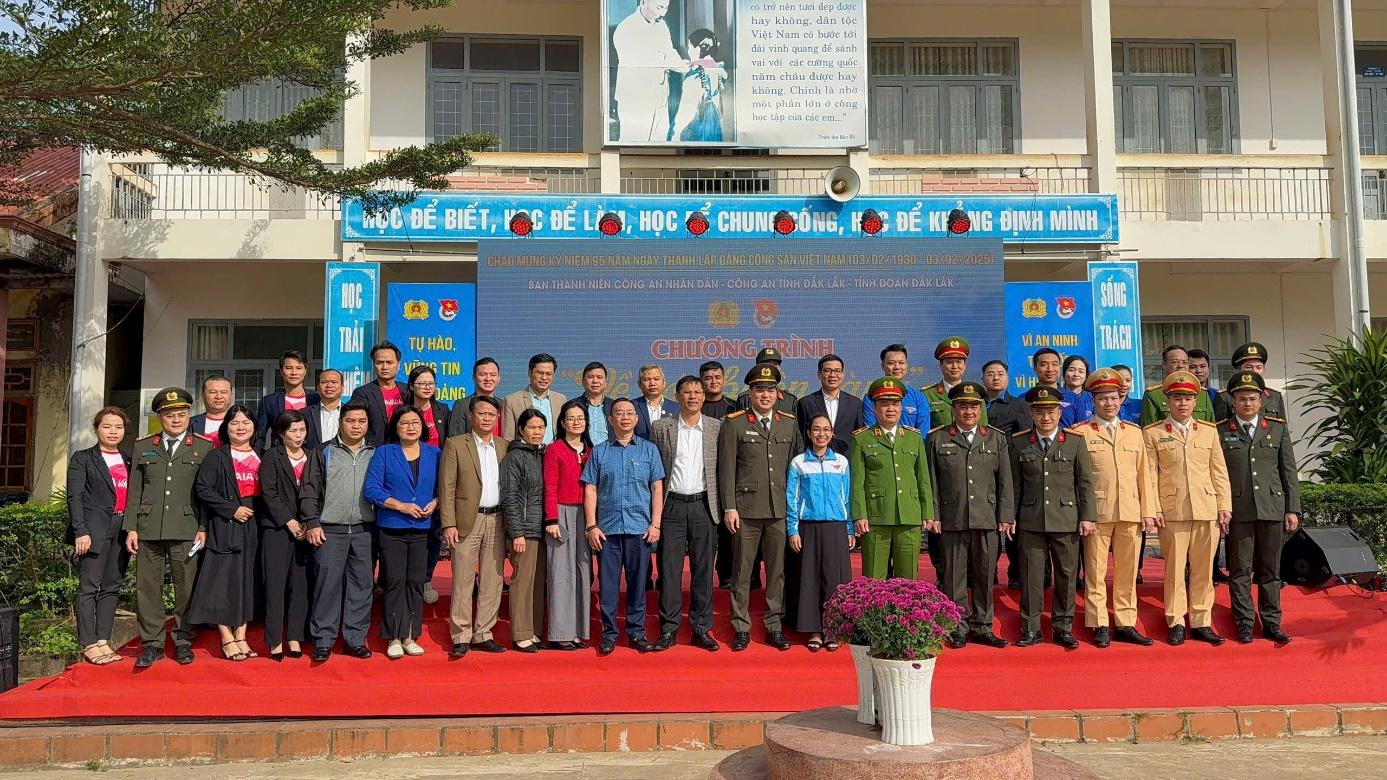 A group of people standing on a red carpetDescription automatically generated