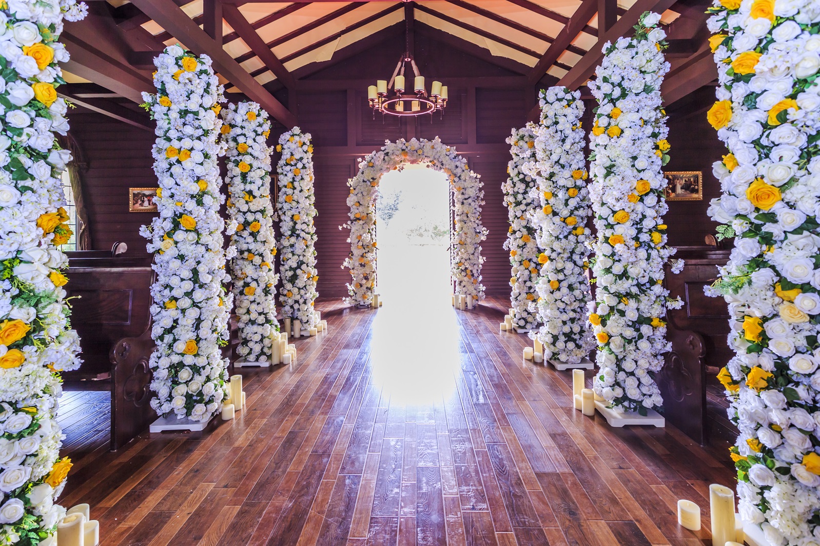 Charming floral archway with white and blush flowers forming a perfect frame over the wedding stage, ideal for romantic ceremonies.