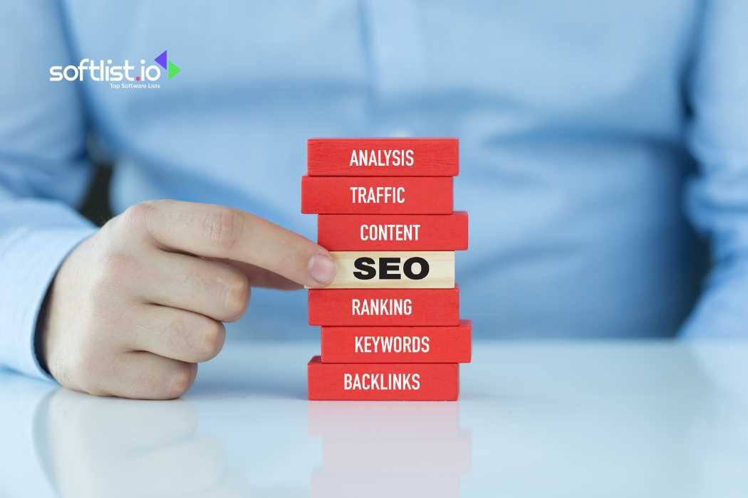 Hand pointing to SEO block in a stack of blocks with related terms