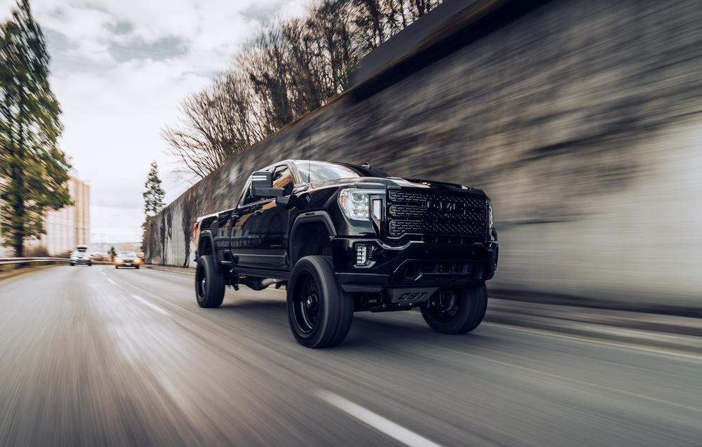 Seattle, WA, USA
March 4, 2022
Black GMC Sierra Denali truck driving on the highway next to a concrete wall