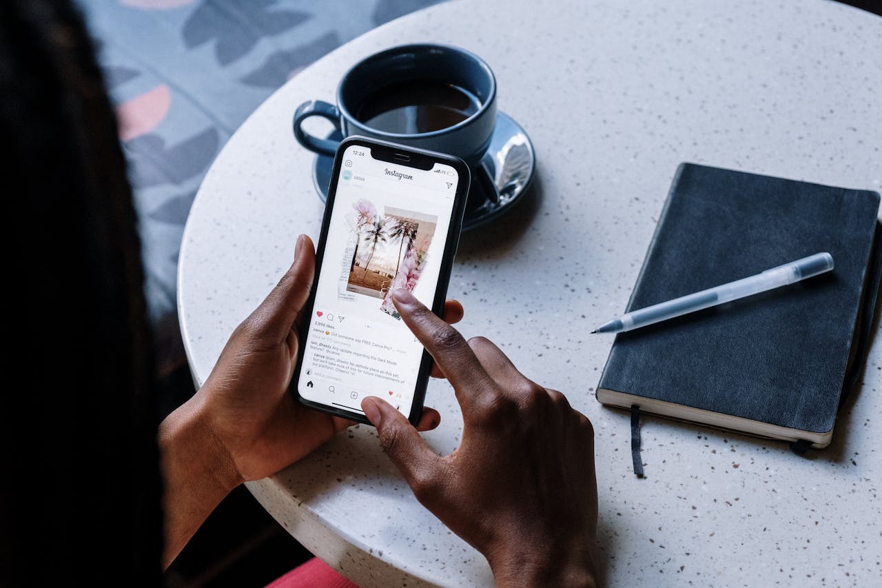 A person holding a smartphone, browsing photos and engaging with followers 