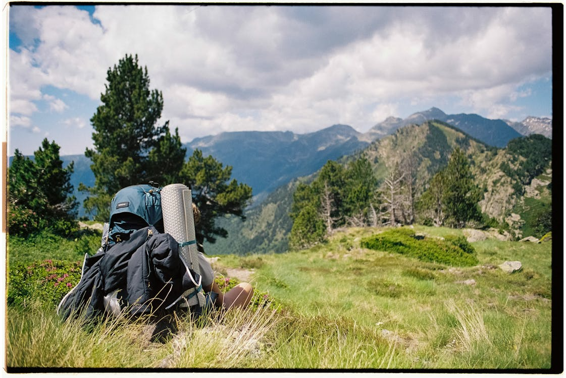 Hiking trails with backpacks in the foreground and mountains in the background. 