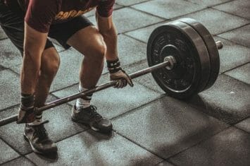 man lifting barbells