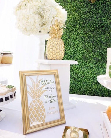 Table decorated for pineapple-themed summer baby shower