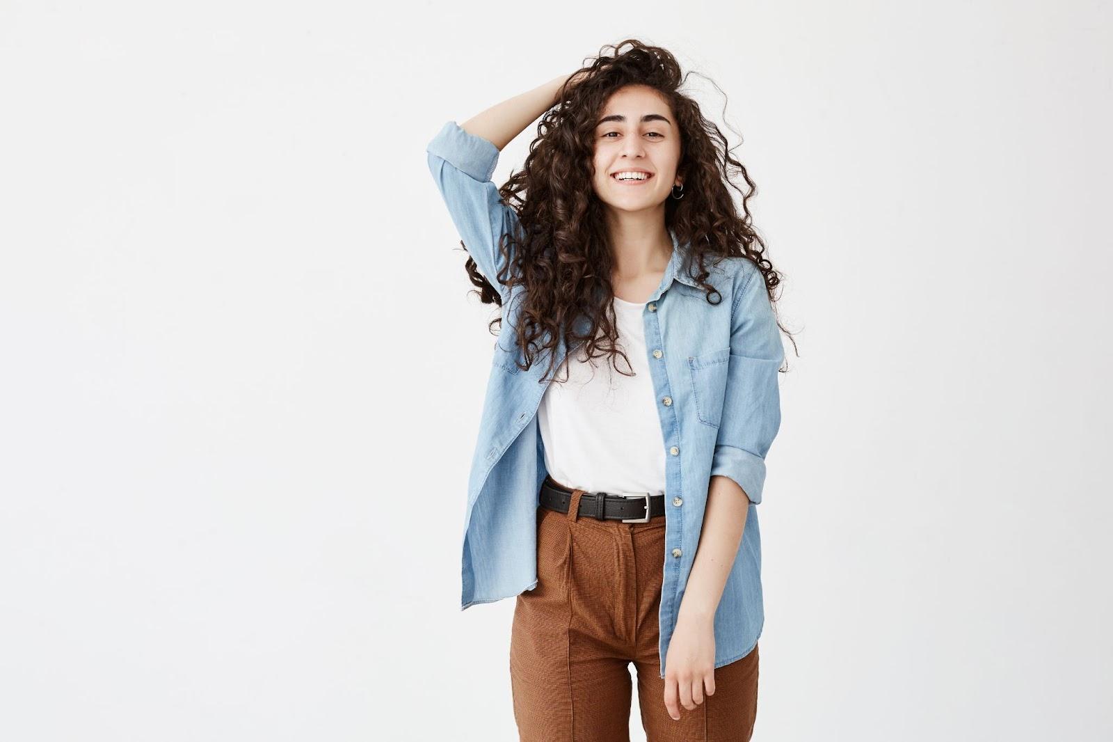 Woman with curly hair posing for the camera