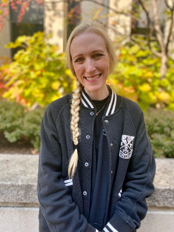 A person with braided hair smiling

Description automatically generated