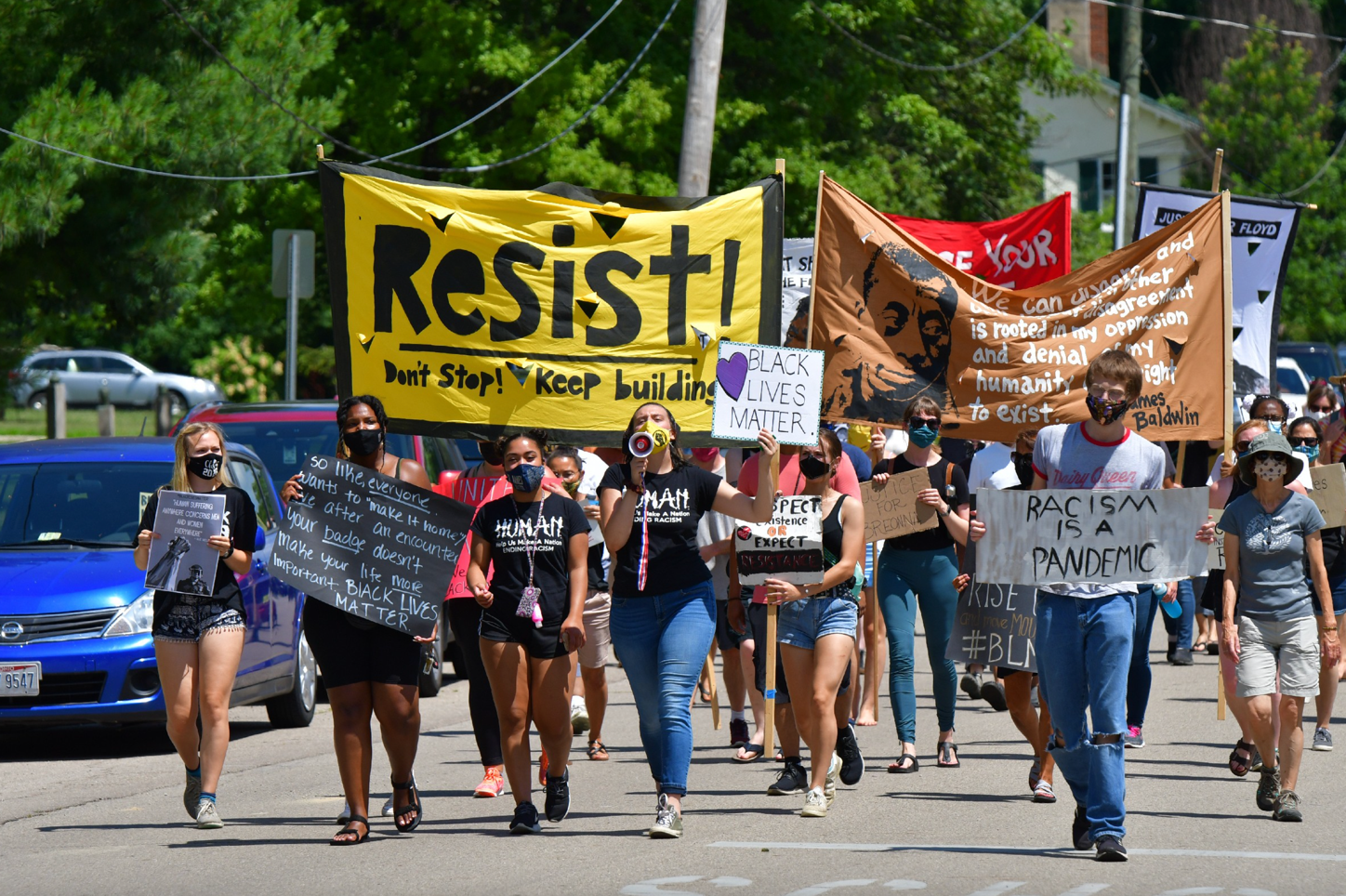 A group of people holding signs

Description automatically generated