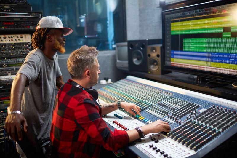 Entertainment of Frequencies  2 men sitting at control panel