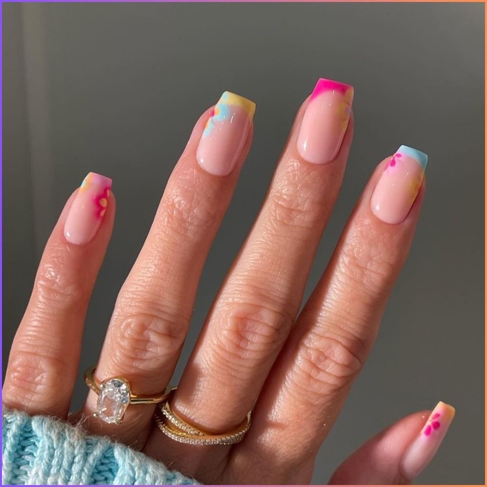 Close up of flowered short nail design with Rainbow french tip nail with flower 