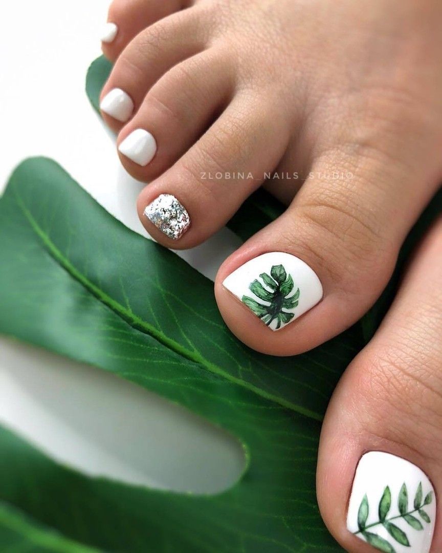 Close-up of toes with palm and leaf pattern