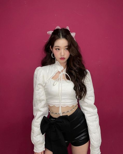 This may contain a photo of  IVE Wonyoung on white crop top and a black short