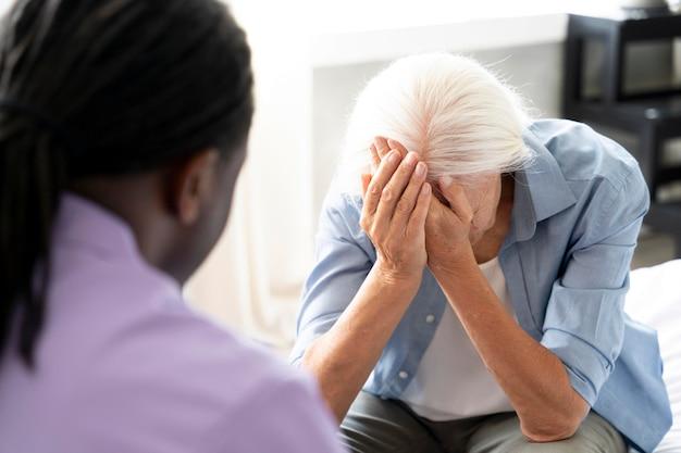 Social worker taking care of a senior woman