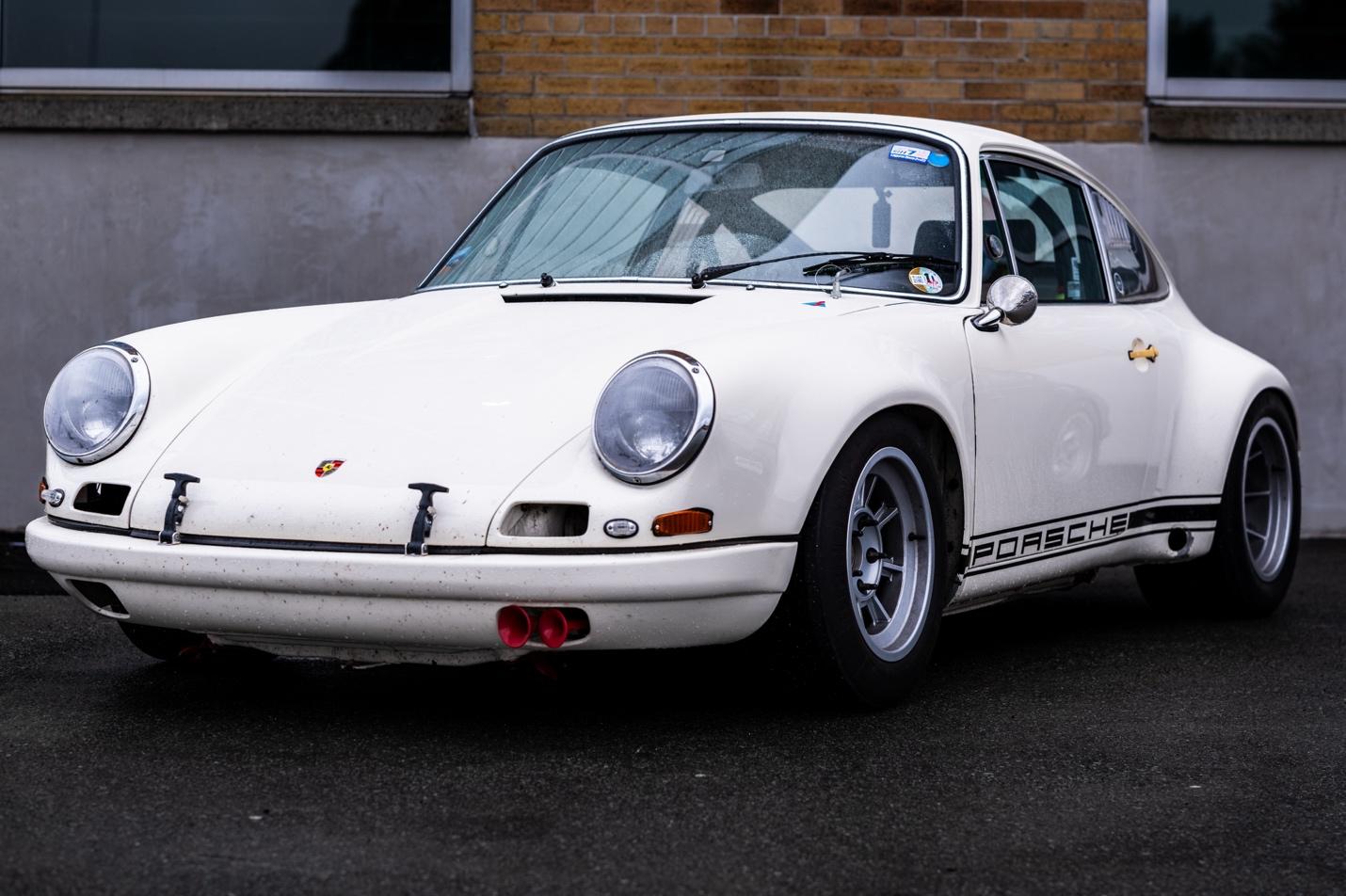 A white car parked in front of a brick building

AI-generated content may be incorrect.