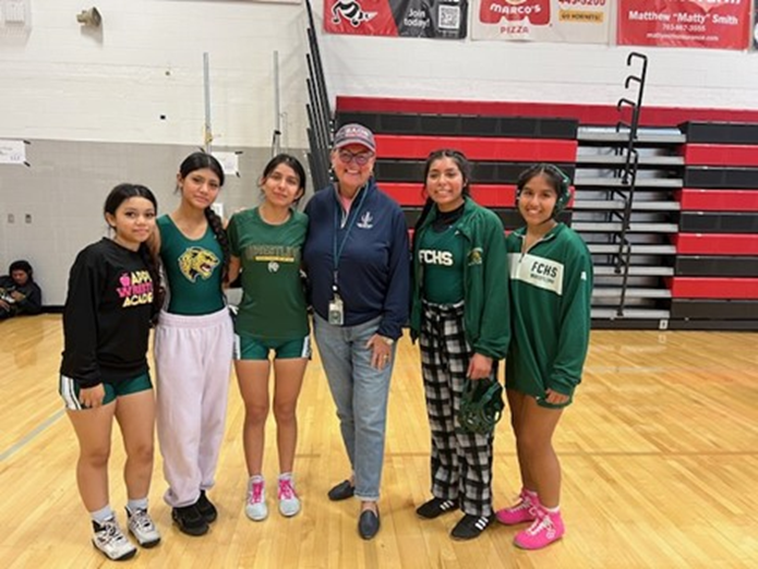 Dr. Reid with a group of female wrestlers at Herndon High School. 