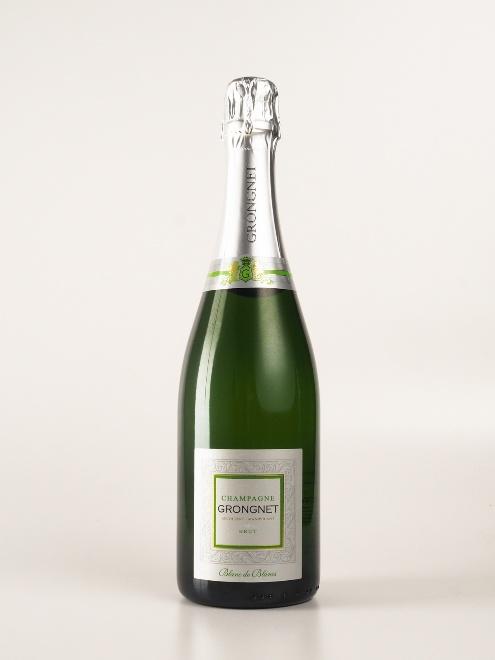 A bottle of champagne with a silver label

Description automatically generated