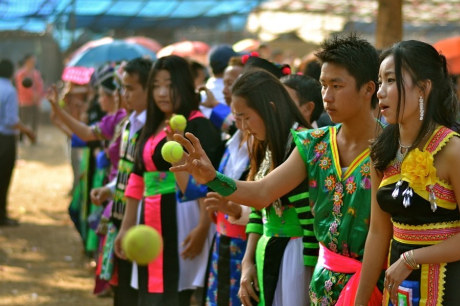 Hmong boys and girls play ball tossing 