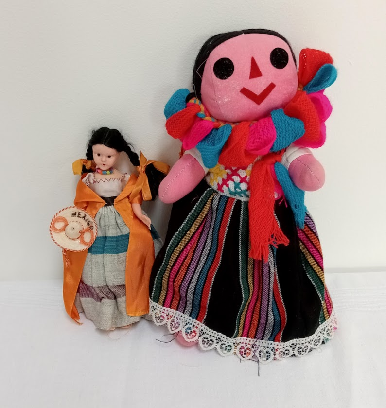 Two Mexican dolls, a more common looking one on the left, and a traditional ragdoll on the right