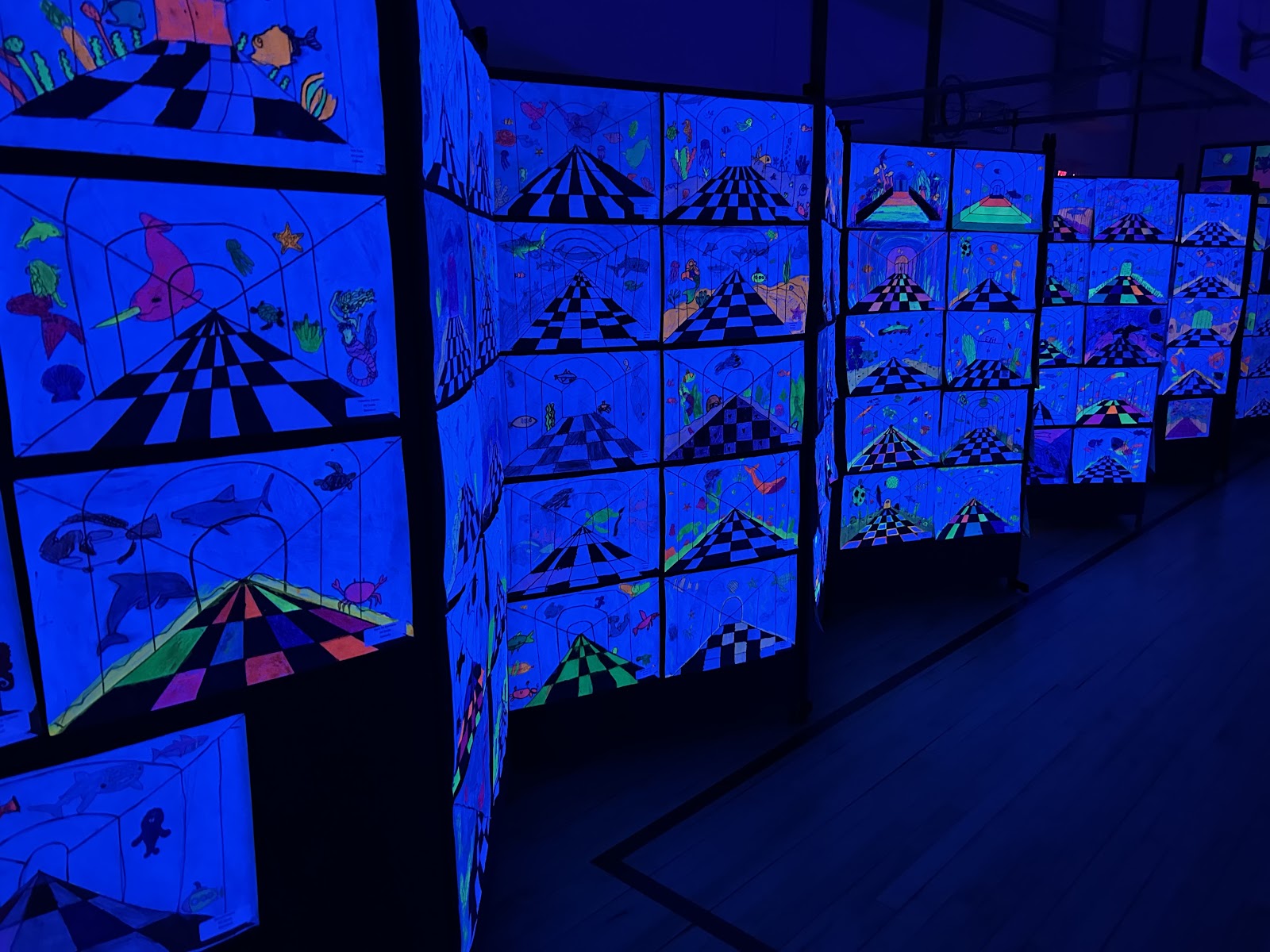 Glow-in-the-dark student artwork on display