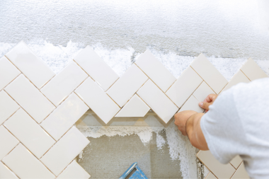 common contractor and remodeling project misconceptions remodeler installing herringbone tiles custom built michigan