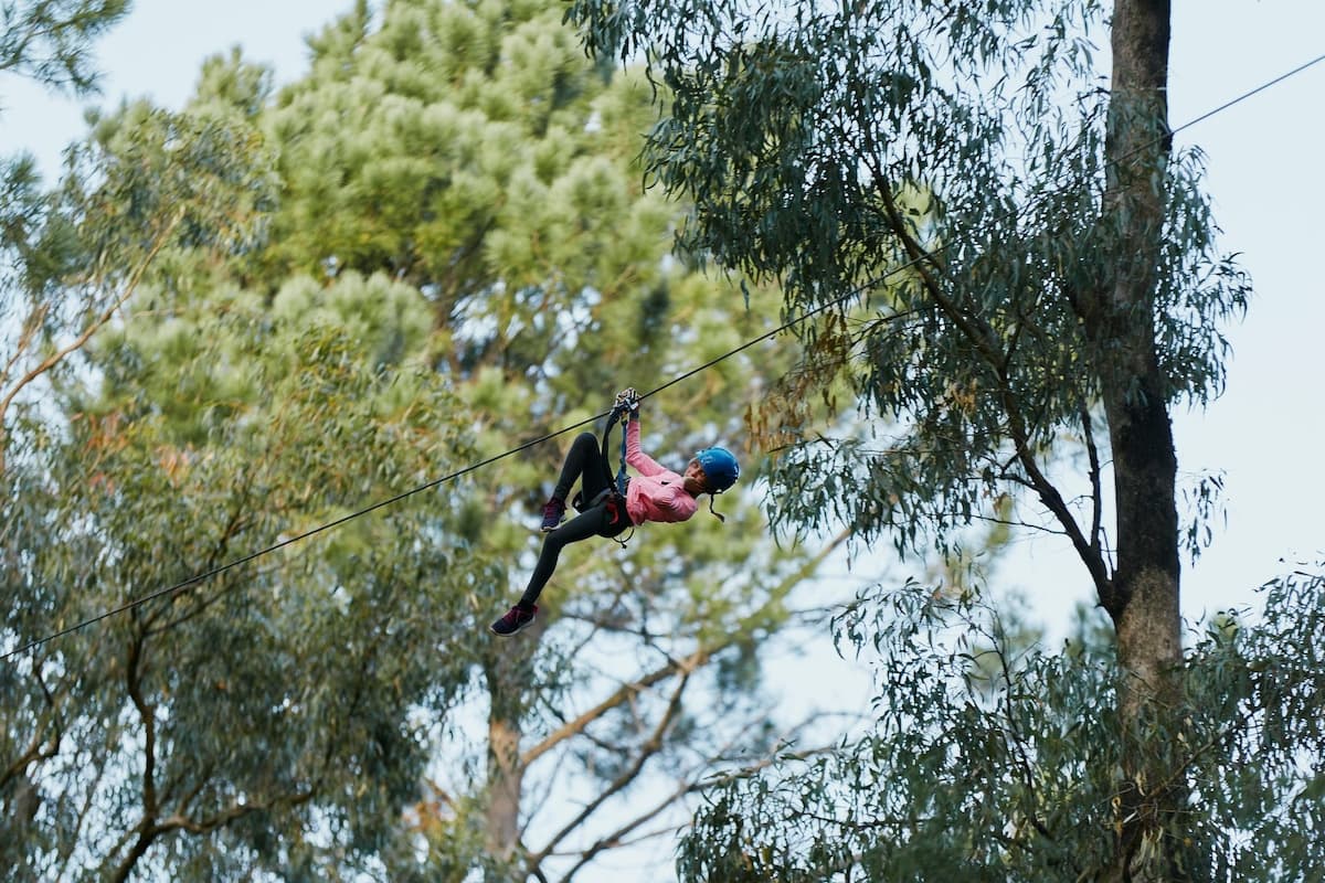 Girl ziplining through the forest at Forest Adventures in Busselton