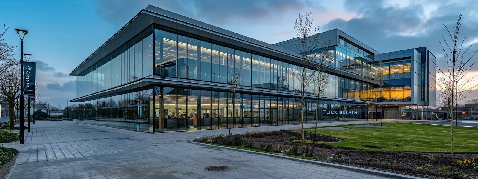 Modern eco-friendly building with large glass windows and sustainable landscaping, showcasing energy-efficient design in Wakefield.