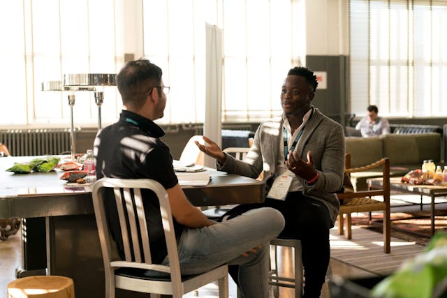 Two people talking to eachother at table