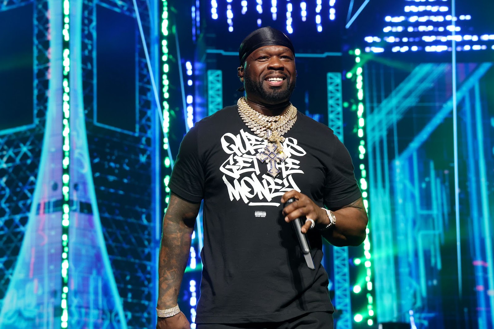 50 Cent performing on stage at the 2025 UK concert at Tottenham Hotspur Stadium.