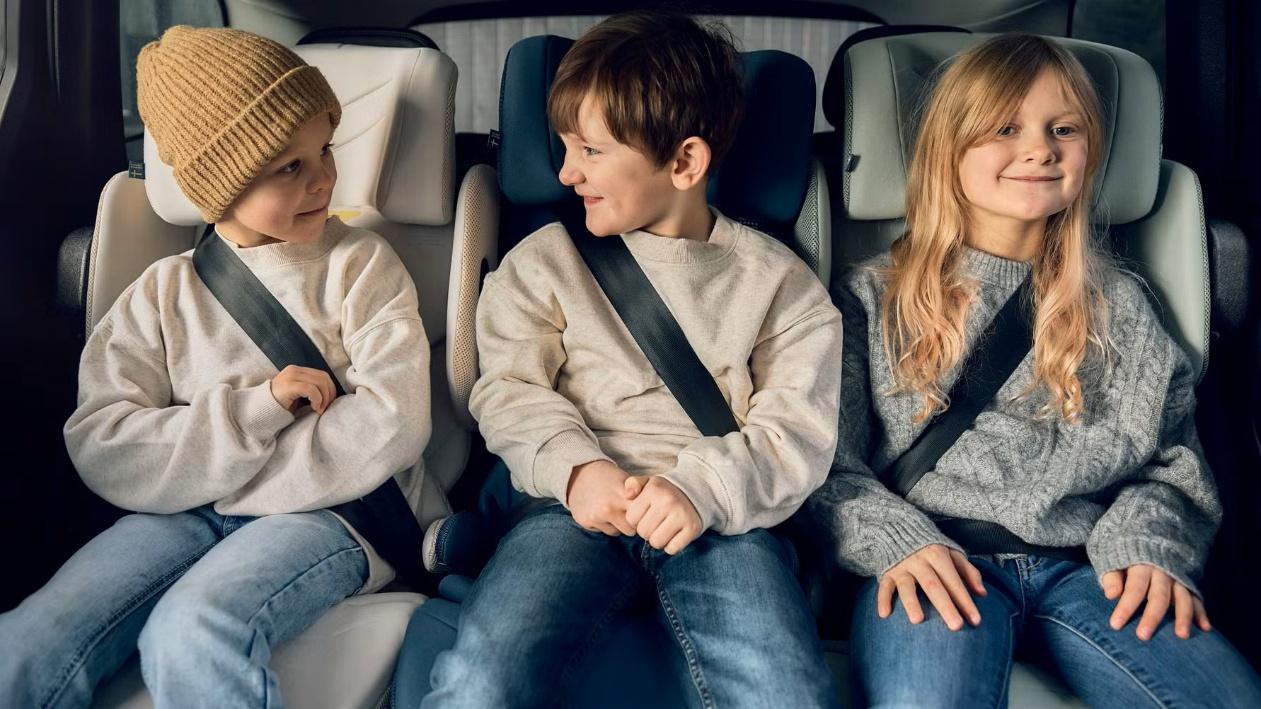 A group of children sitting in a car AI-generated content may be incorrect.