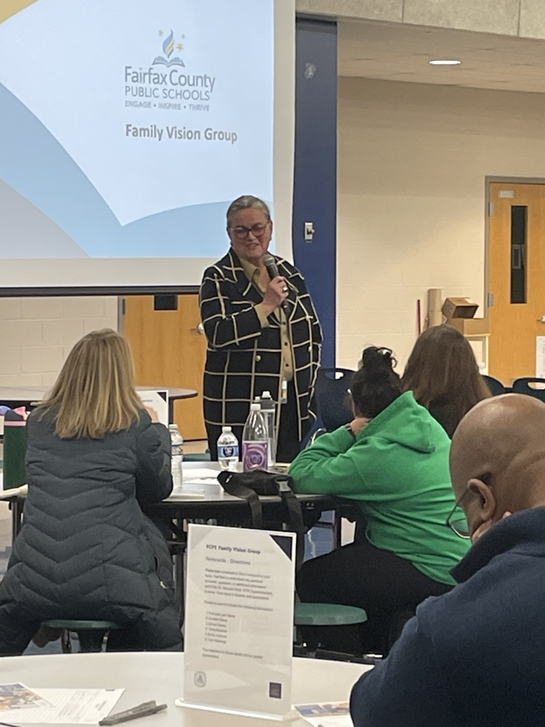 Dr. Reid speaking in front of a group of parents at a Family Vision Group meeting. 