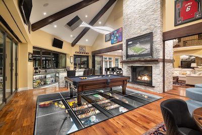 Pool table in a room with a fireplace and other furniture.