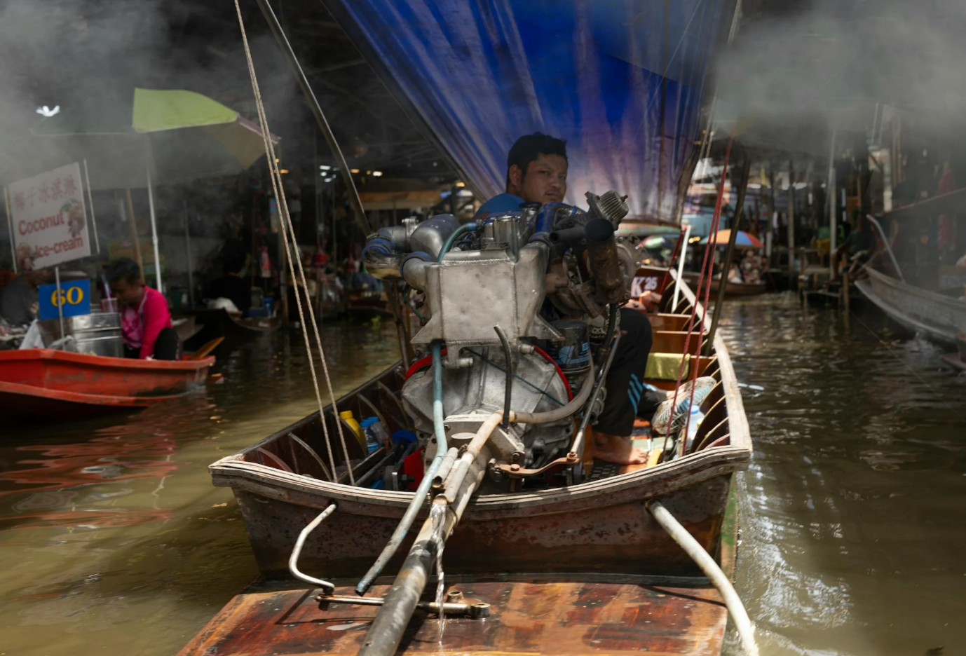 A person in a boat with a motor

Description automatically generated