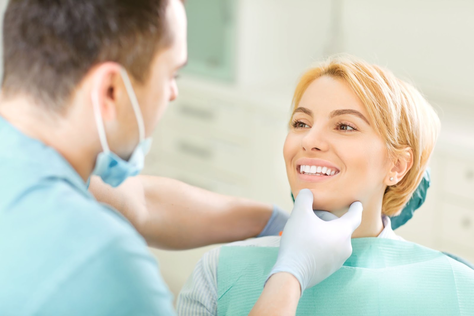 A dentist examining a patient's teeth to monitor alignment and check for any issues related to shifting teeth.