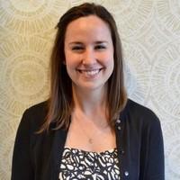 A person smiling for the camera Description automatically generated with medium confidence