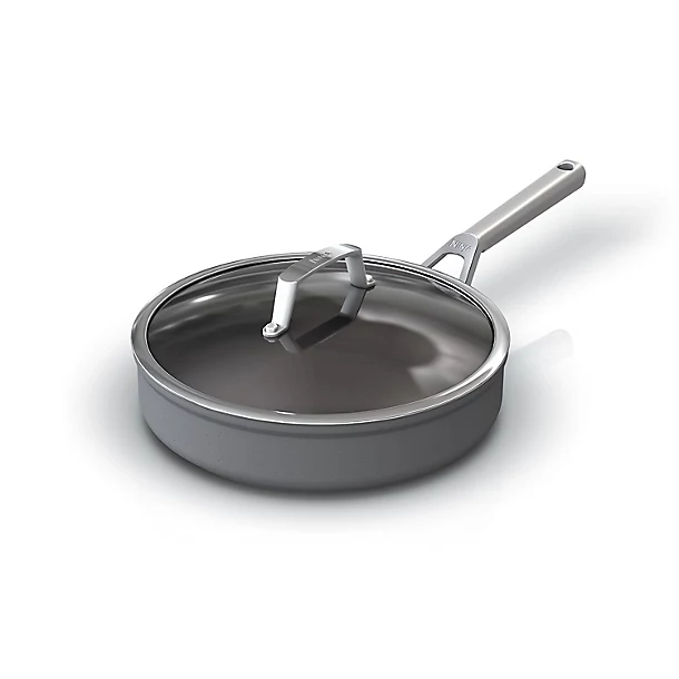 A grey non-stick sauté pan with a long handle and a glass lid on a white background.