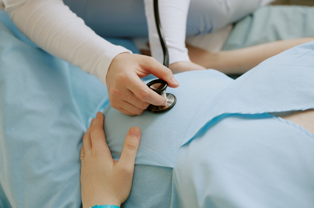 Pregnant medical worker laying on doctor's bed // Healthier Baby Today