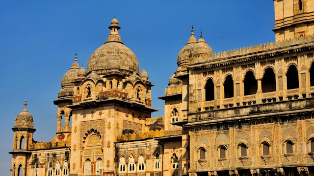 A majestic building showcasing Indo-Saracenic architecture with ornate domes and intricate carvings.