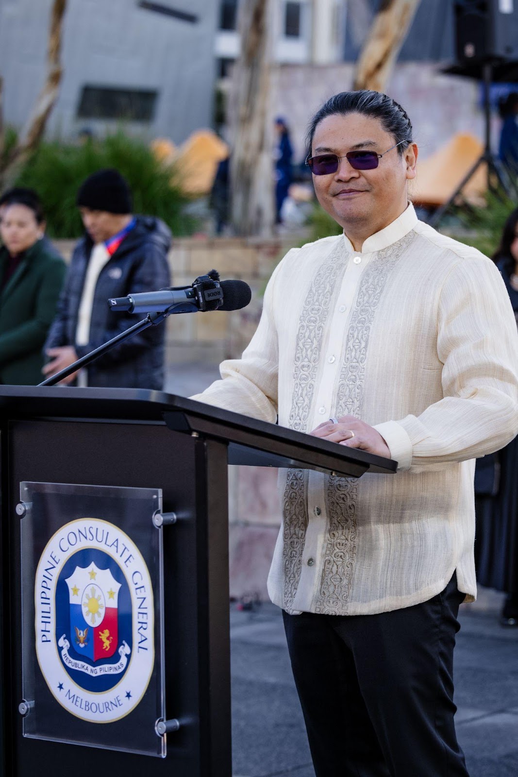 A person standing at a podiumDescription automatically generated