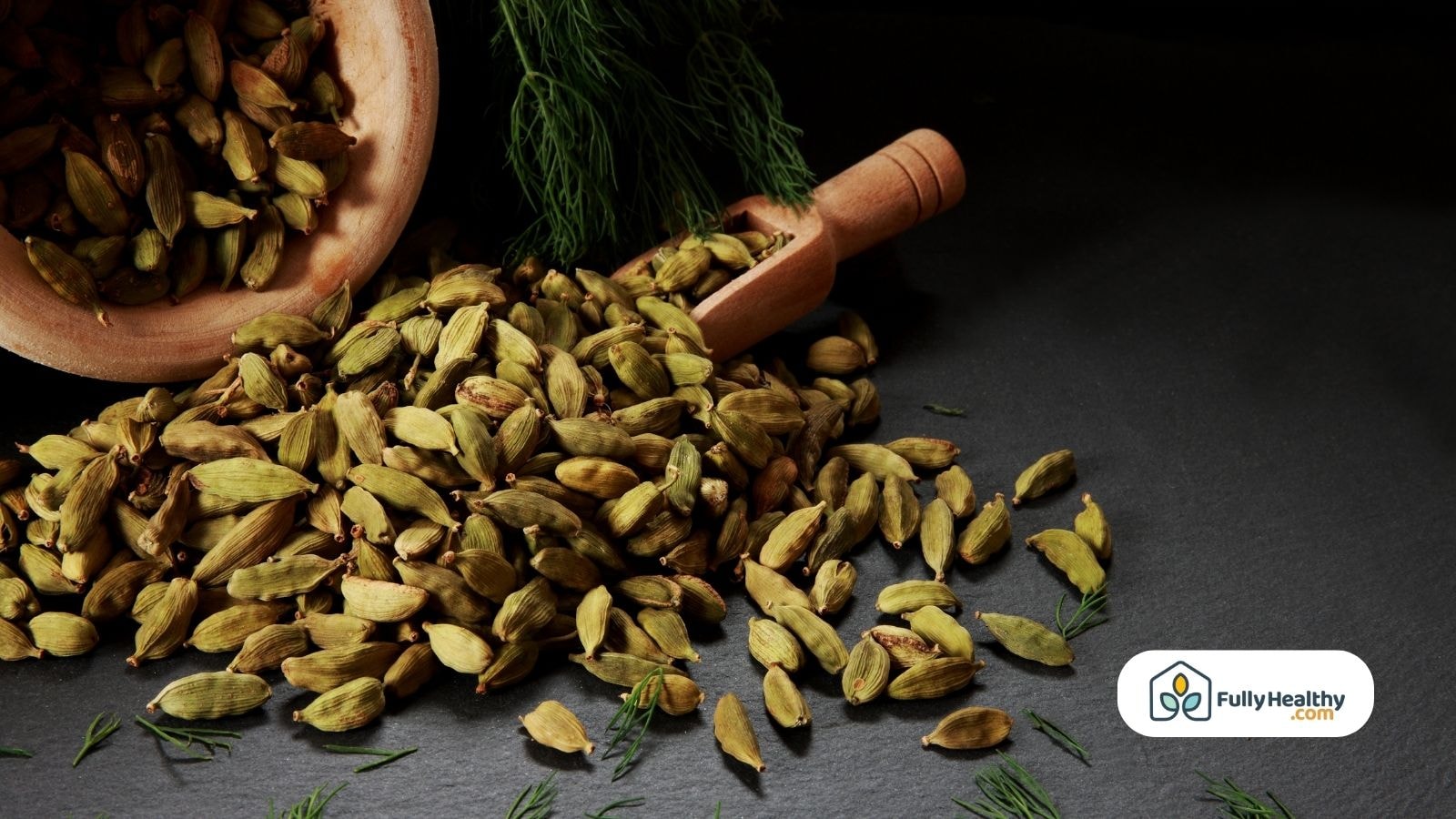 Overflowing bowl of green cardamom pods on black background