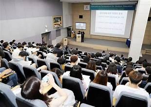 A group of people in a lecture hall

AI-generated content may be incorrect.