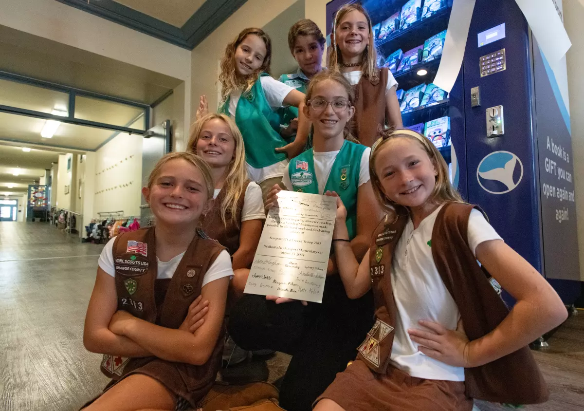 Girl Scouts pose with donated book vending machine